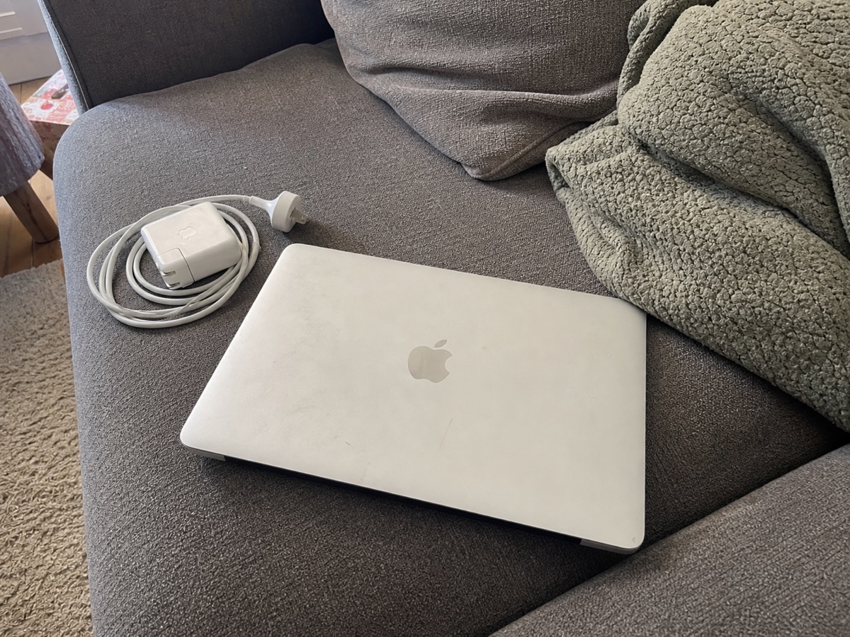 MacBook photographed on a couch for Marketplace deal sourcing